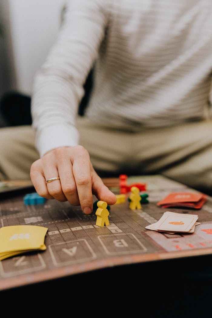 Close up of a Man Taking a Counter on a Game Board